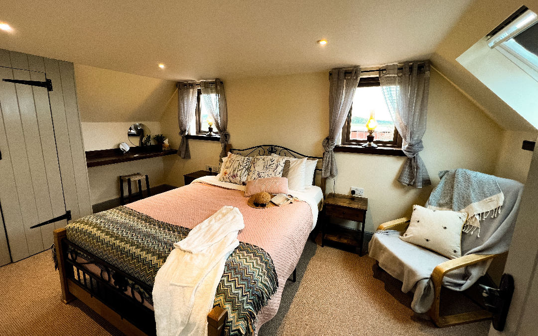 Norfolk Coastal Cottages, The Dairy has a large master bedroom with quirky windows that look west and have stunning sunset views across the Norfolk Countryside
