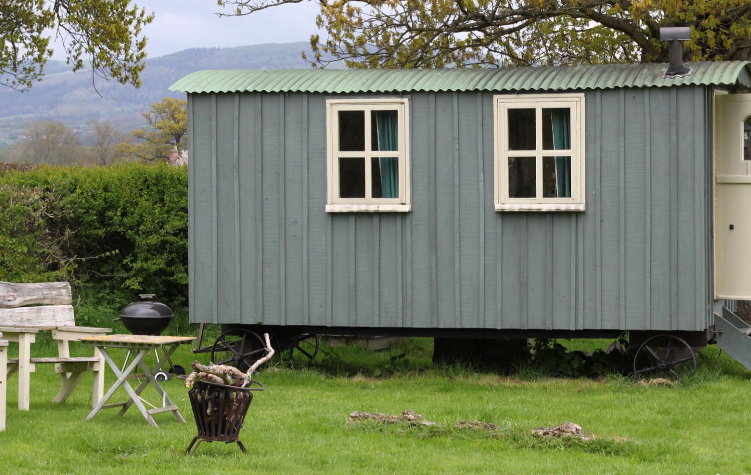 Traditional shepherd's hut with a hilly backdrop