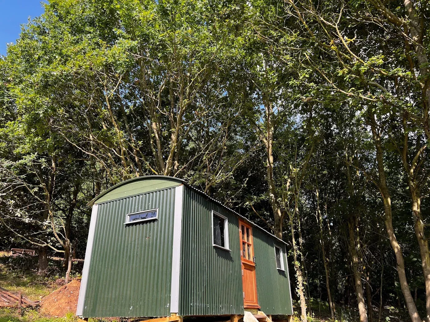 a person with their dog outside of a shepherd hut